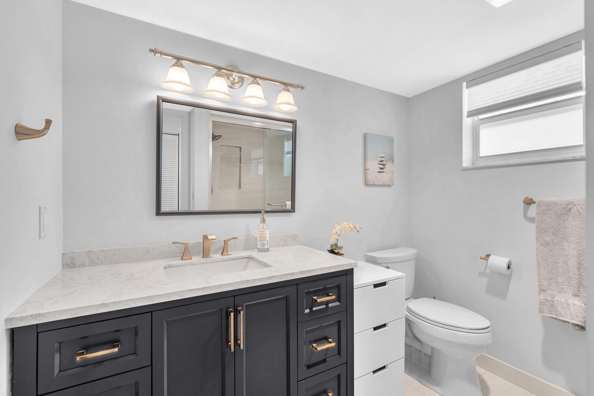 3 Colonial Club Drive, Unit 300 Boynton Beach, FL 33435 - Photo 20 of 71 a bathroom with a toilet sink and mirror