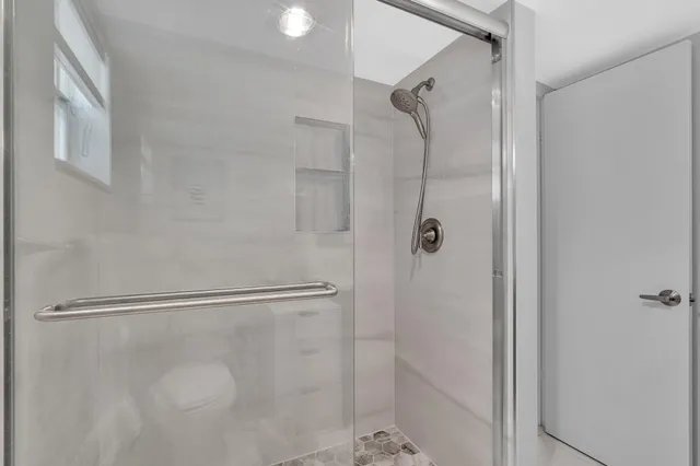 a bathroom with a granite countertop toilet sink and mirror