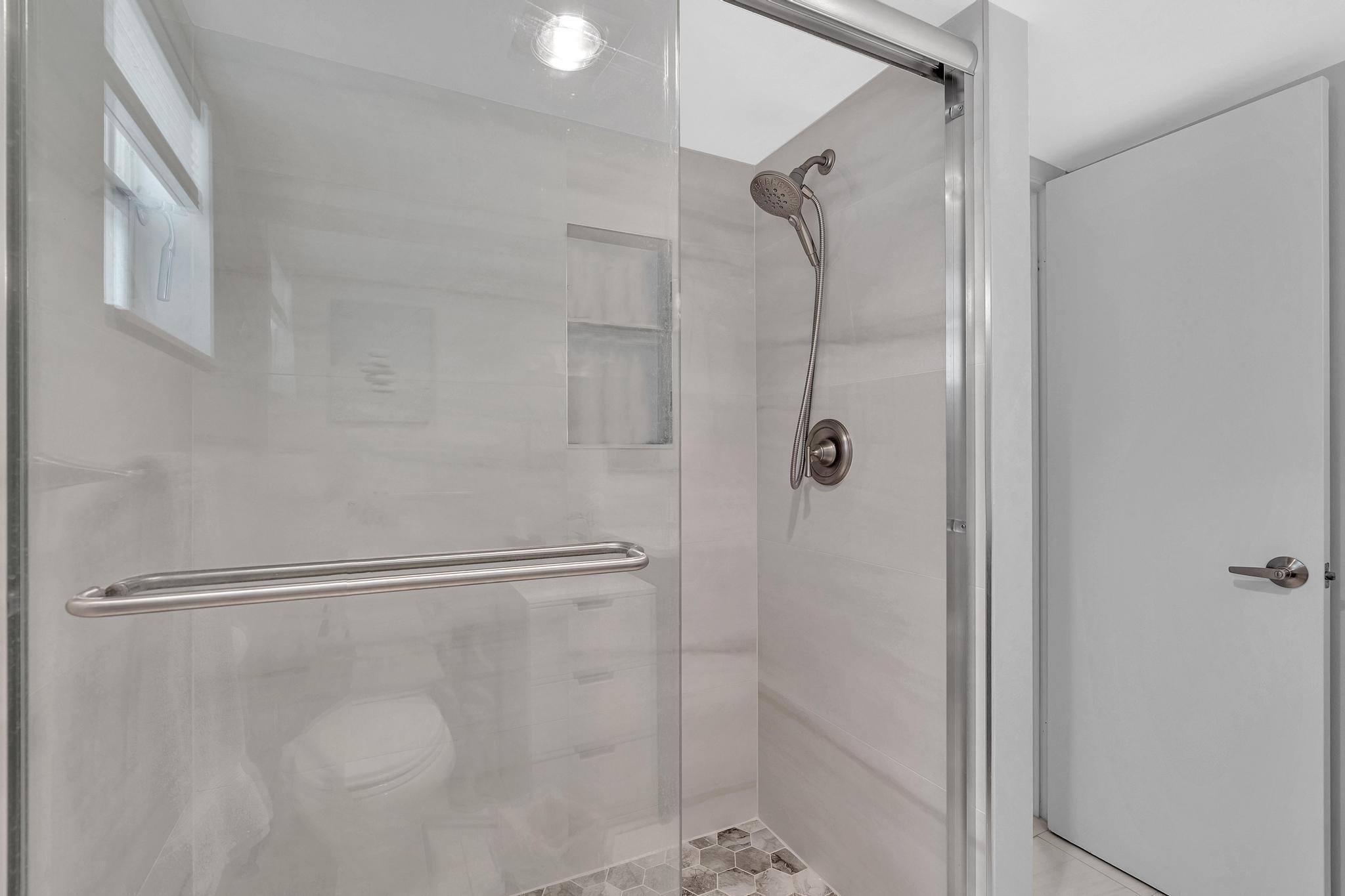 3 Colonial Club Drive, Unit 300 Boynton Beach, FL 33435 - Photo 21 of 71 a bathroom with a glass shower door
