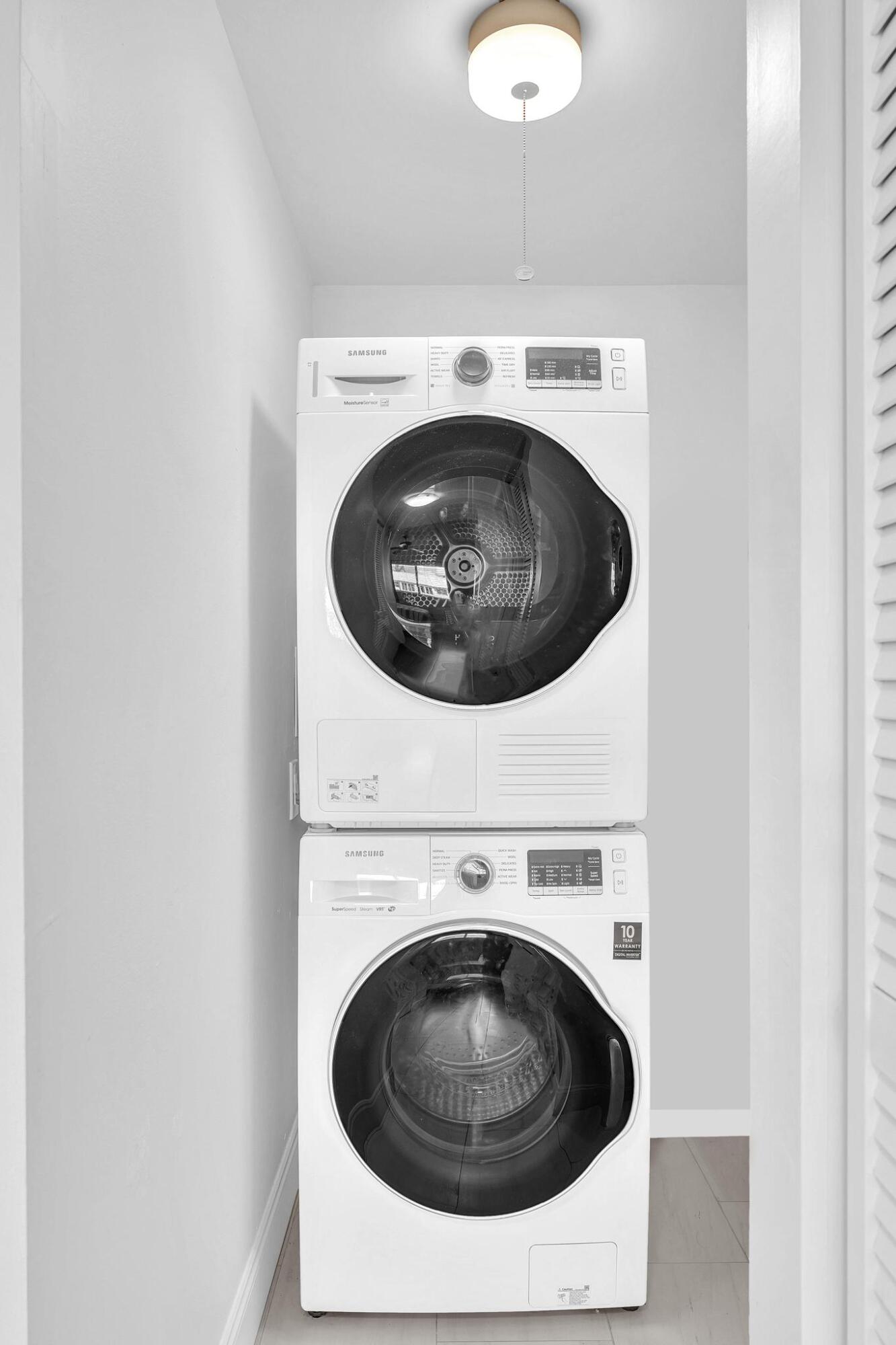3 Colonial Club Drive, Unit 300 Boynton Beach, FL 33435 - Photo 22 of 71 a utility room with dryer and washer