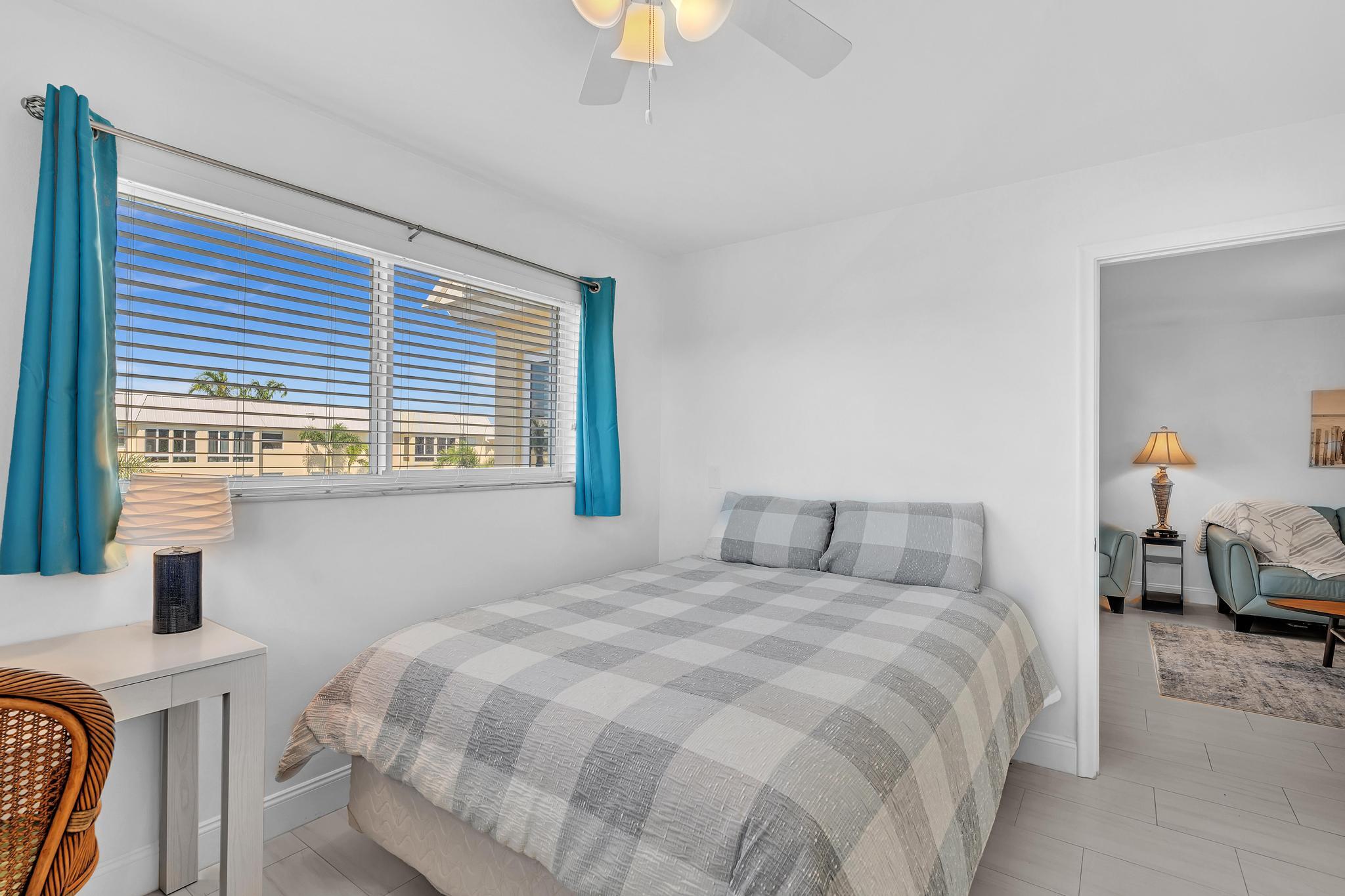 3 Colonial Club Drive, Unit 300 Boynton Beach, FL 33435 - Photo 23 of 71 a bedroom with a bed and a chandelier