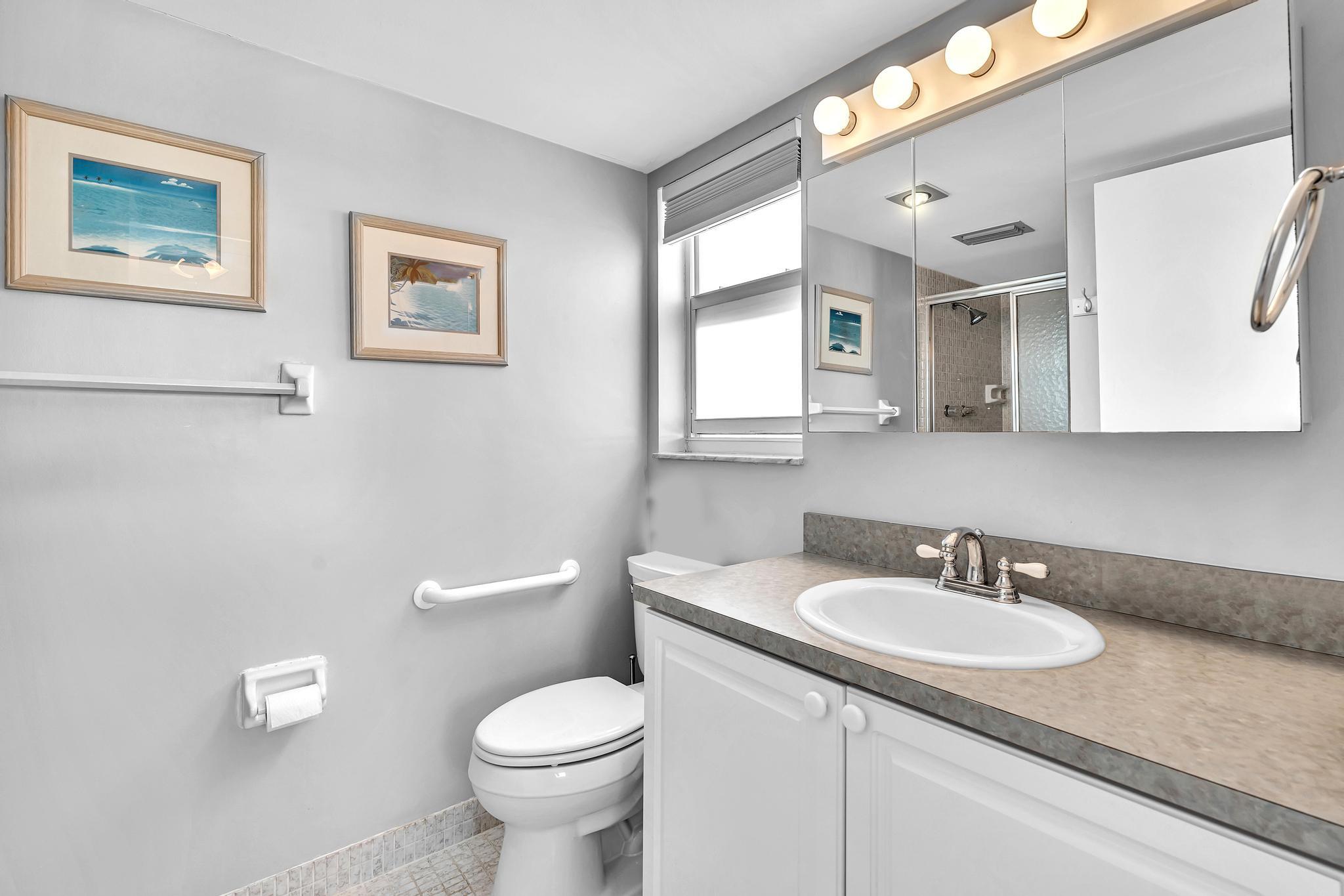 3 Colonial Club Drive, Unit 300 Boynton Beach, FL 33435 - Photo 25 of 71 a bathroom with a granite countertop toilet sink and mirror