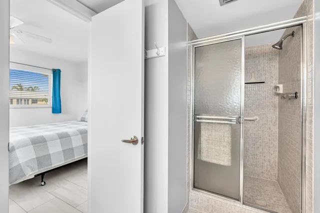 a view of a patio with lawn chairs dining table and chairs under an umbrella