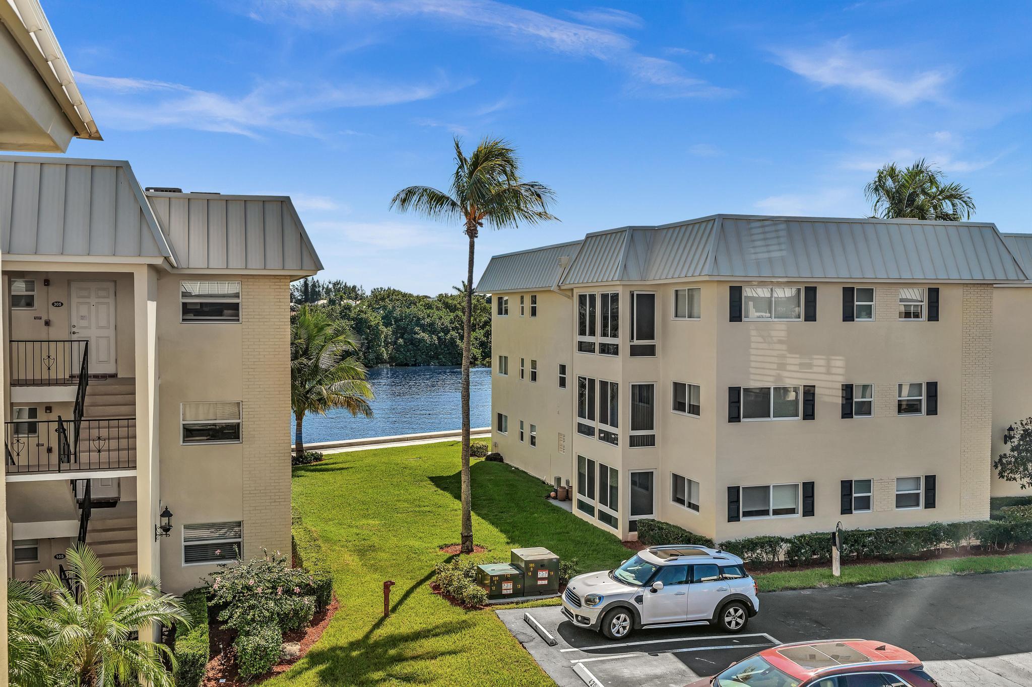 3 Colonial Club Drive, Unit 300 Boynton Beach, FL 33435 - Photo 28 of 71 a car parked in front of a building