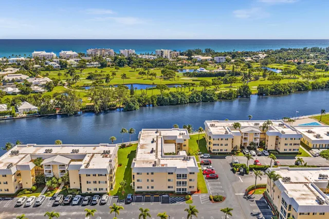 an aerial view of house with outdoor space and lake view