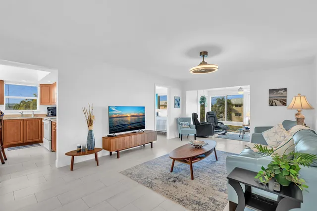 a living room with furniture a rug and a large mirror