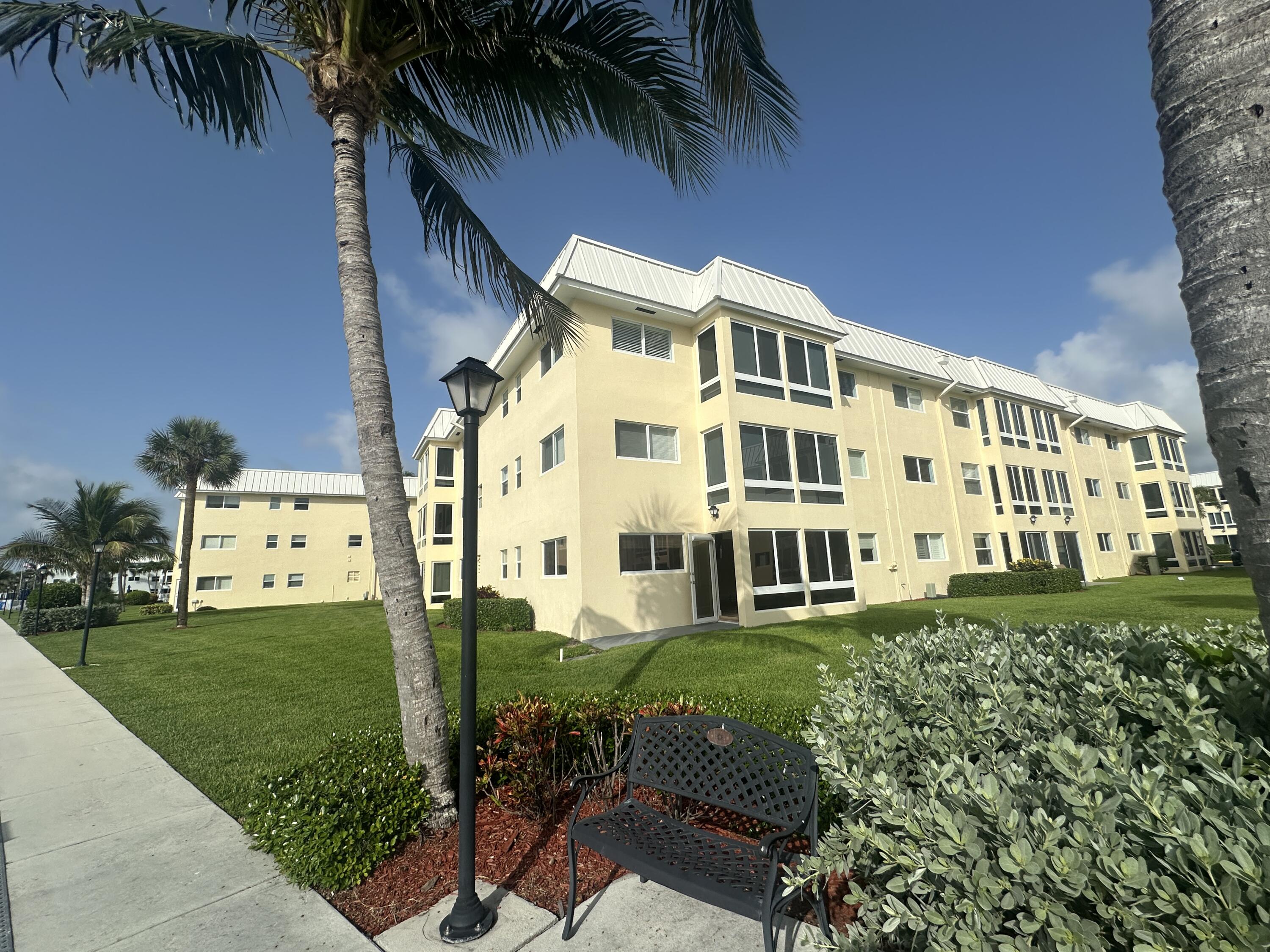 3 Colonial Club Drive, Unit 300 Boynton Beach, FL 33435 - Photo 42 of 71 a view of a building with a yard