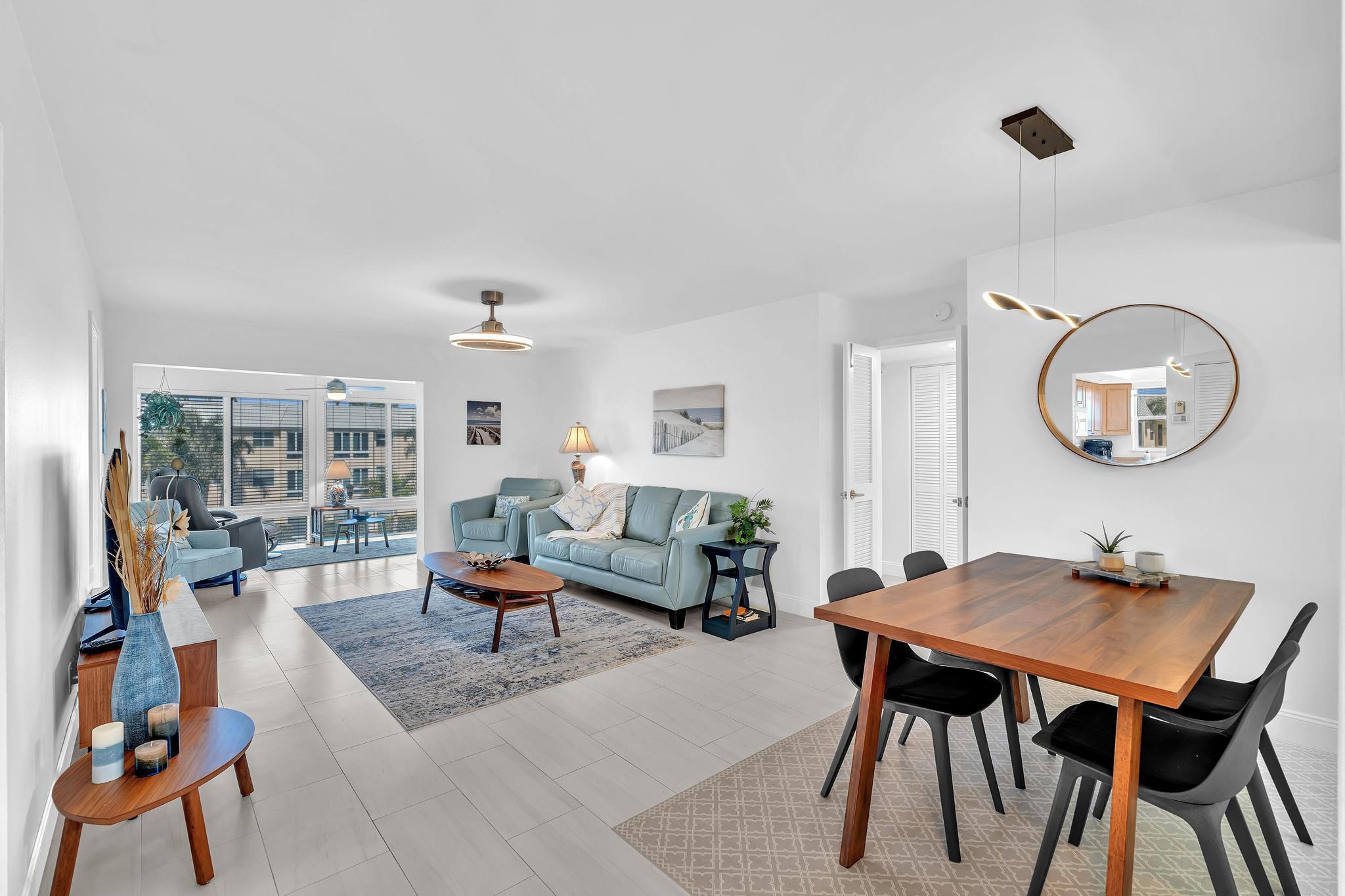 3 Colonial Club Drive, Unit 300 Boynton Beach, FL 33435 - Photo 6 of 71 a living room with furniture a rug and a large mirror