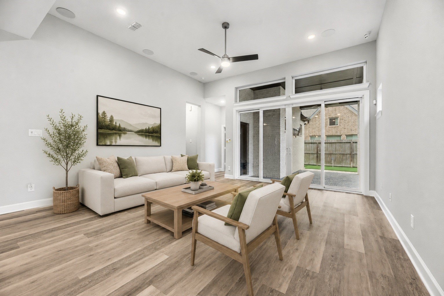 3438 Rich Radish Road Richmond, TX 77406 - Photo 4 of 25 A different perspective of the spacious living area highlights the expansive sliding glass doors that frame views of the private rear grounds and flood the entire interior with natural light. Virtually staged.