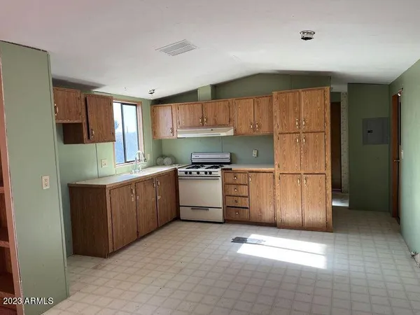 a kitchen with stainless steel appliances granite countertop a refrigerator sink and cabinets