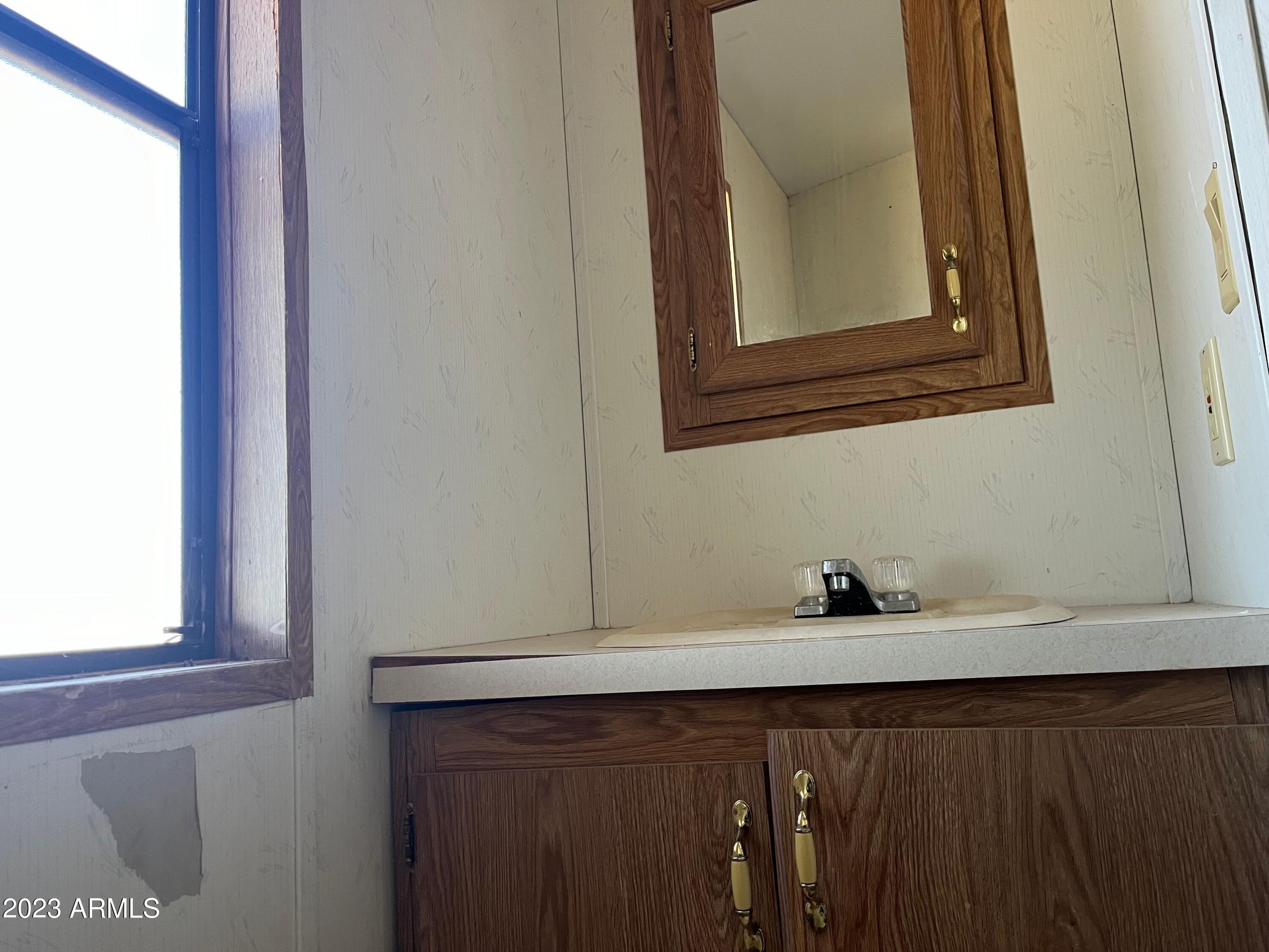 2902 Applewhite Drive Douglas, AZ 85607 - Photo 7 of 11 a bathroom with a sink and a mirror
