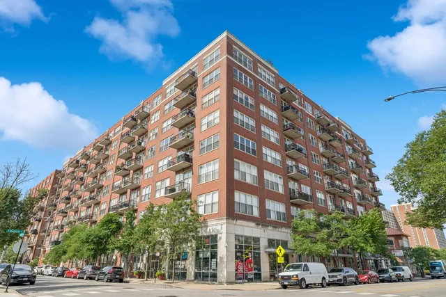 a view of a tall building next to a road