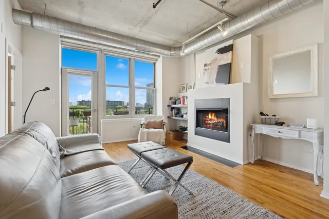 a living room with furniture fireplace and window