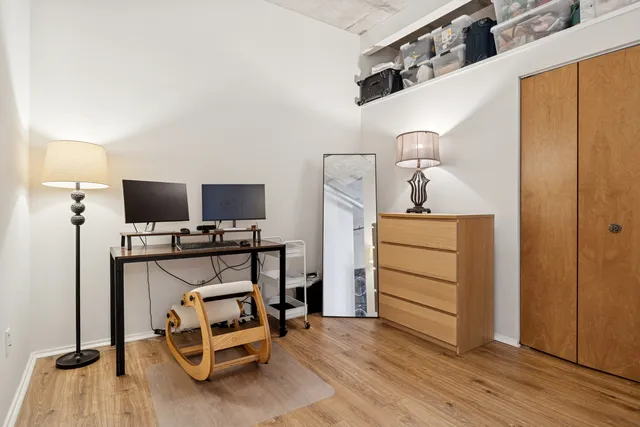 a view of room with wooden floor and furniture