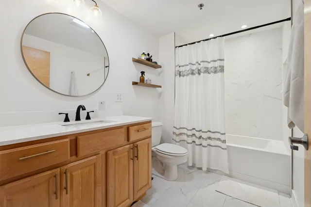 a bathroom with a sink a toilet and a mirror