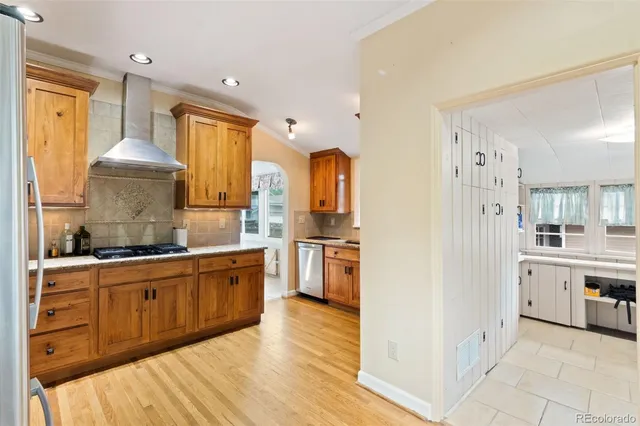 a large kitchen with cabinets and wooden floor