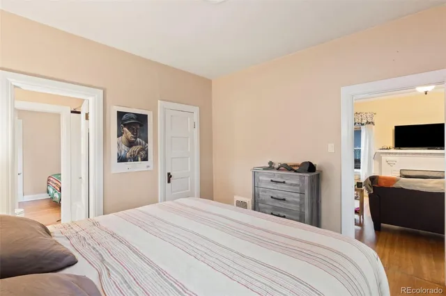 a bedroom with a bed and flat screen tv