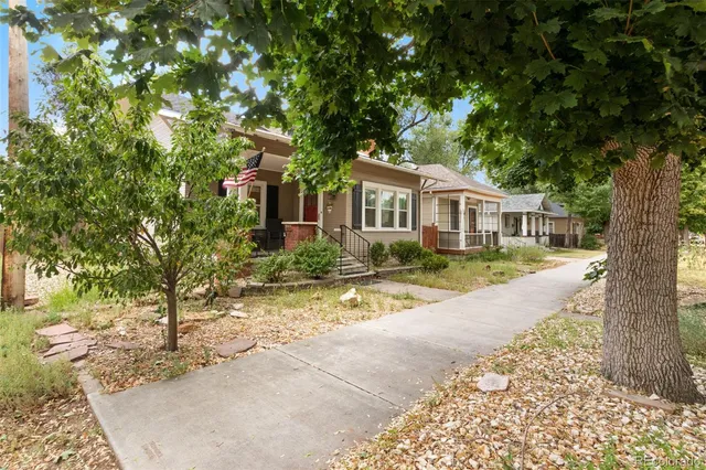front view of a house with a tree in front of it