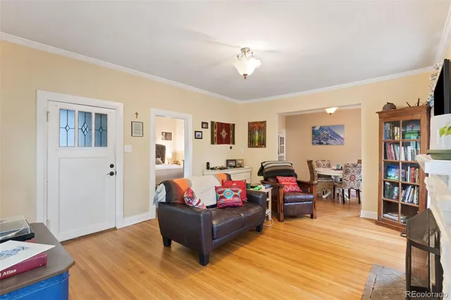 a living room with furniture and wooden floor