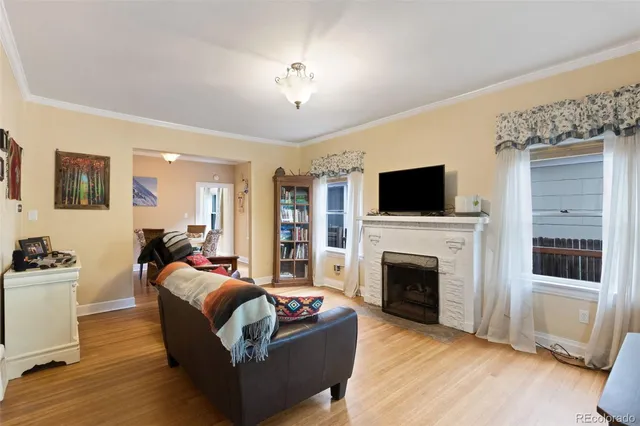 a living room with fireplace furniture and a flat screen tv
