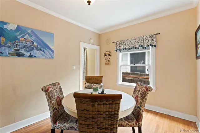 a dining room with furniture and wooden floor