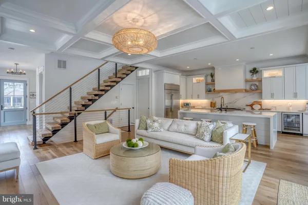a living room with furniture and kitchen view