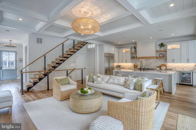 a living room with furniture and kitchen view