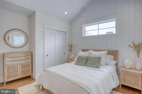 a bedroom with a bed and a table in it with window