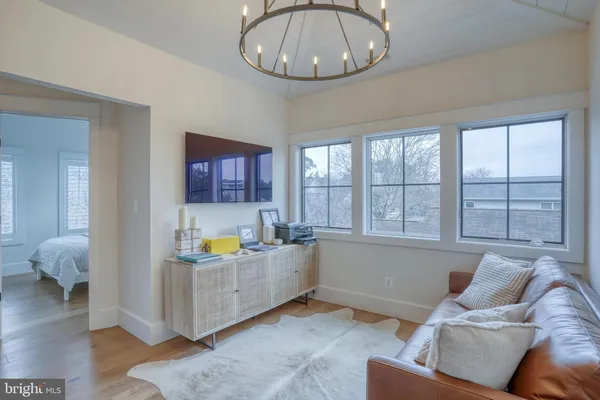 a bedroom with a large bed and a chandelier
