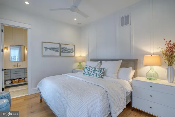 a bedroom with a large bed and a chandelier