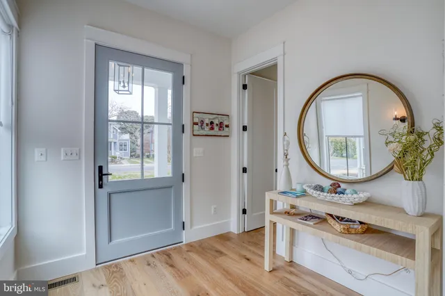 a bedroom with a bed and a lamp on dresser