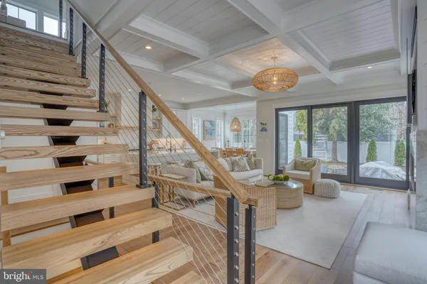 a living room with furniture a mirror and a wooden floor