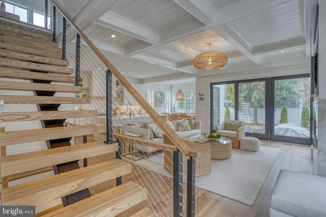 a living room with furniture a mirror and a wooden floor