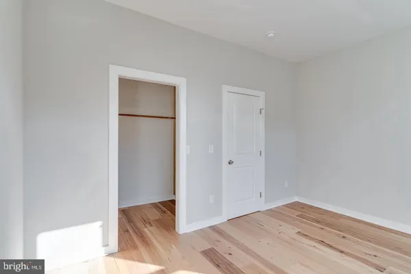 a view of a room with wooden floor and window