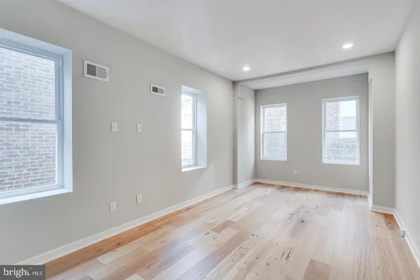 wooden floor in a room next to a window