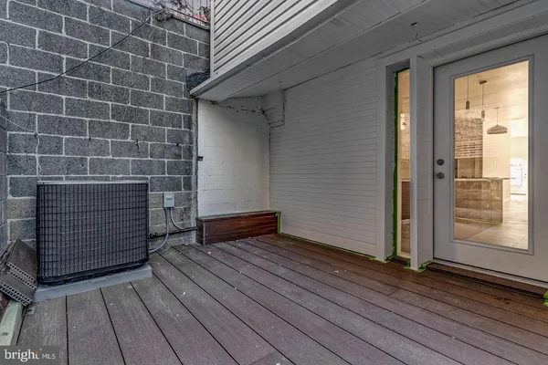 a view of a bedroom with wooden floor and staircase