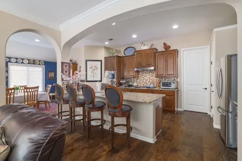 a large kitchen with a table and chairs