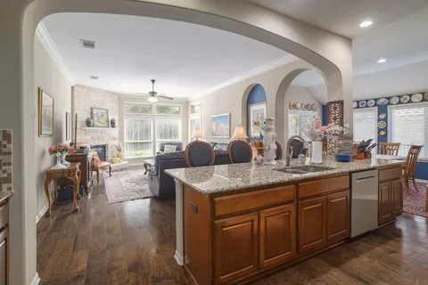 a view of living room with granite countertop furniture and wooden floor