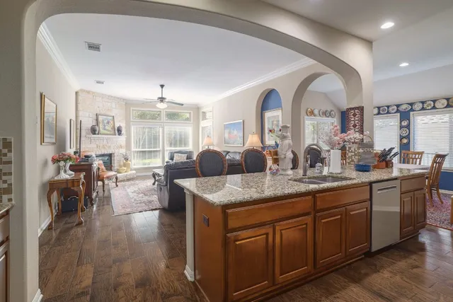 a view of living room with granite countertop furniture and wooden floor