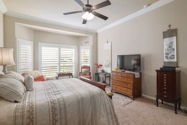 a bedroom with a bed and a television