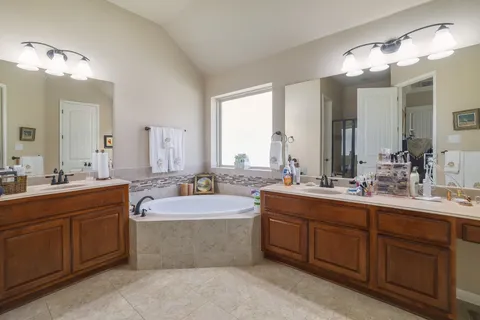 a large bathroom with a double vanity sink mirror and double
