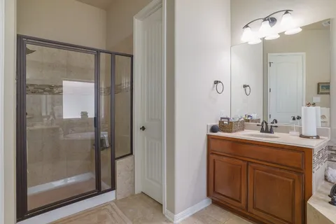 a bathroom with a shower sink and mirror