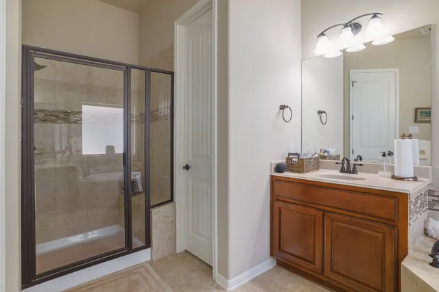 a bathroom with a shower sink and mirror