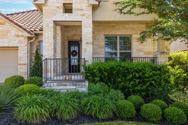 front view of a house with a garden
