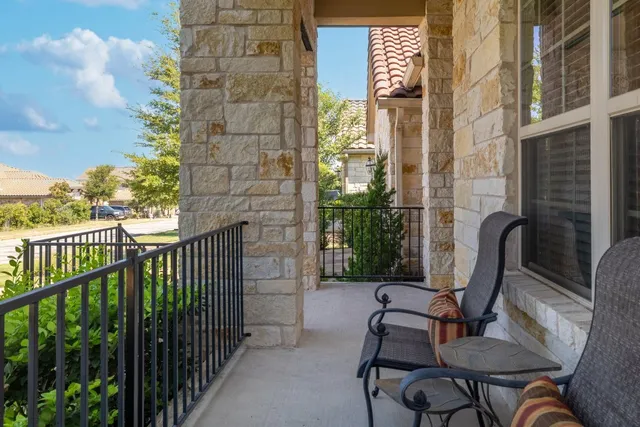a view of a balcony with chairs