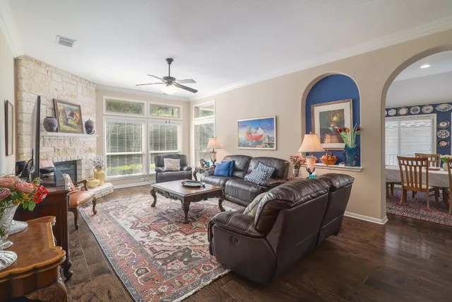 a living room with furniture a fireplace and wooden floor