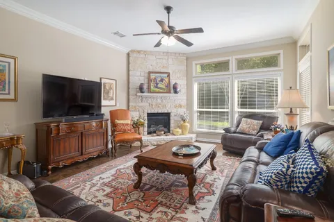 a living room with furniture a flat screen tv and a fireplace
