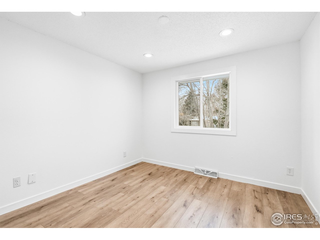 4559 Beachcomber Court Boulder, CO 80301 - Photo 13 of 22 an empty room with wooden floor and window