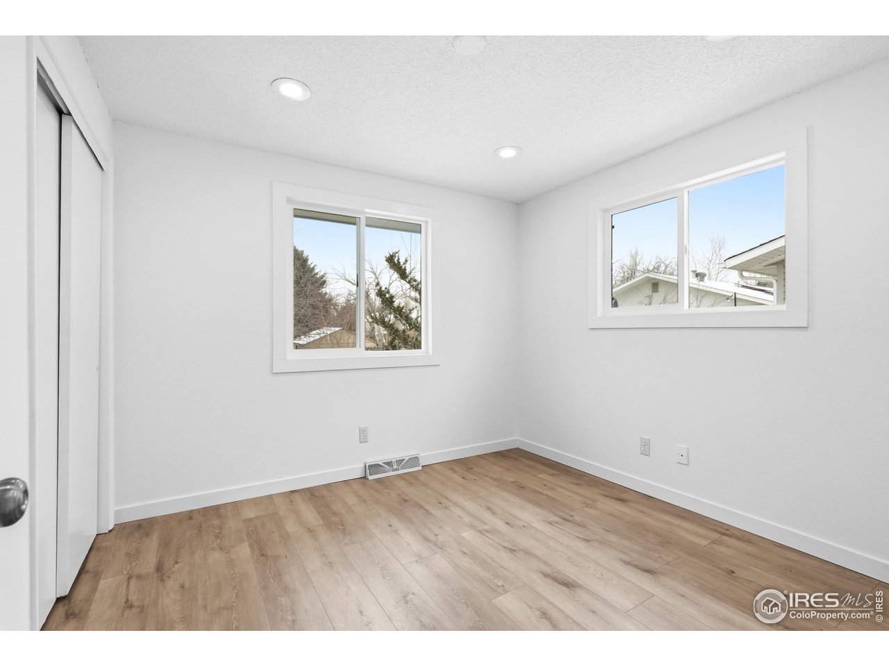 4559 Beachcomber Court Boulder, CO 80301 - Photo 14 of 22 an empty room with wooden floor and painting on the wall