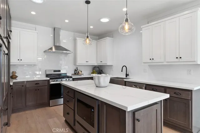 a kitchen with a sink a stove and cabinets